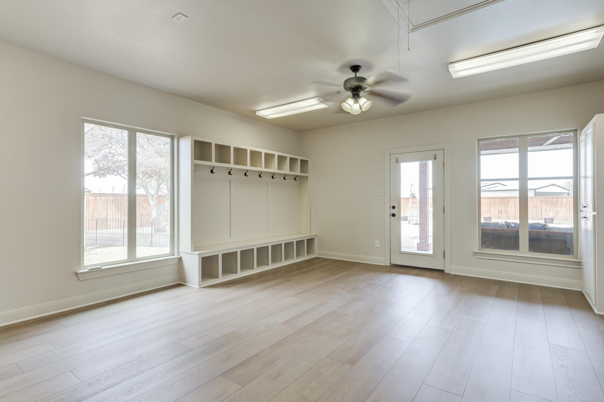 3206 County Road 7610 Lubbock, TX 79423 - Photo 66 of 93 an empty room with wooden floor fan and windows