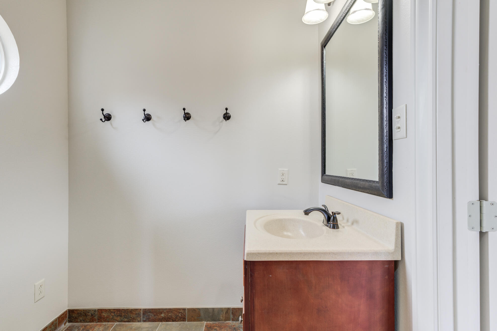 3206 County Road 7610 Lubbock, TX 79423 - Photo 68 of 93 a bathroom with a sink and a mirror