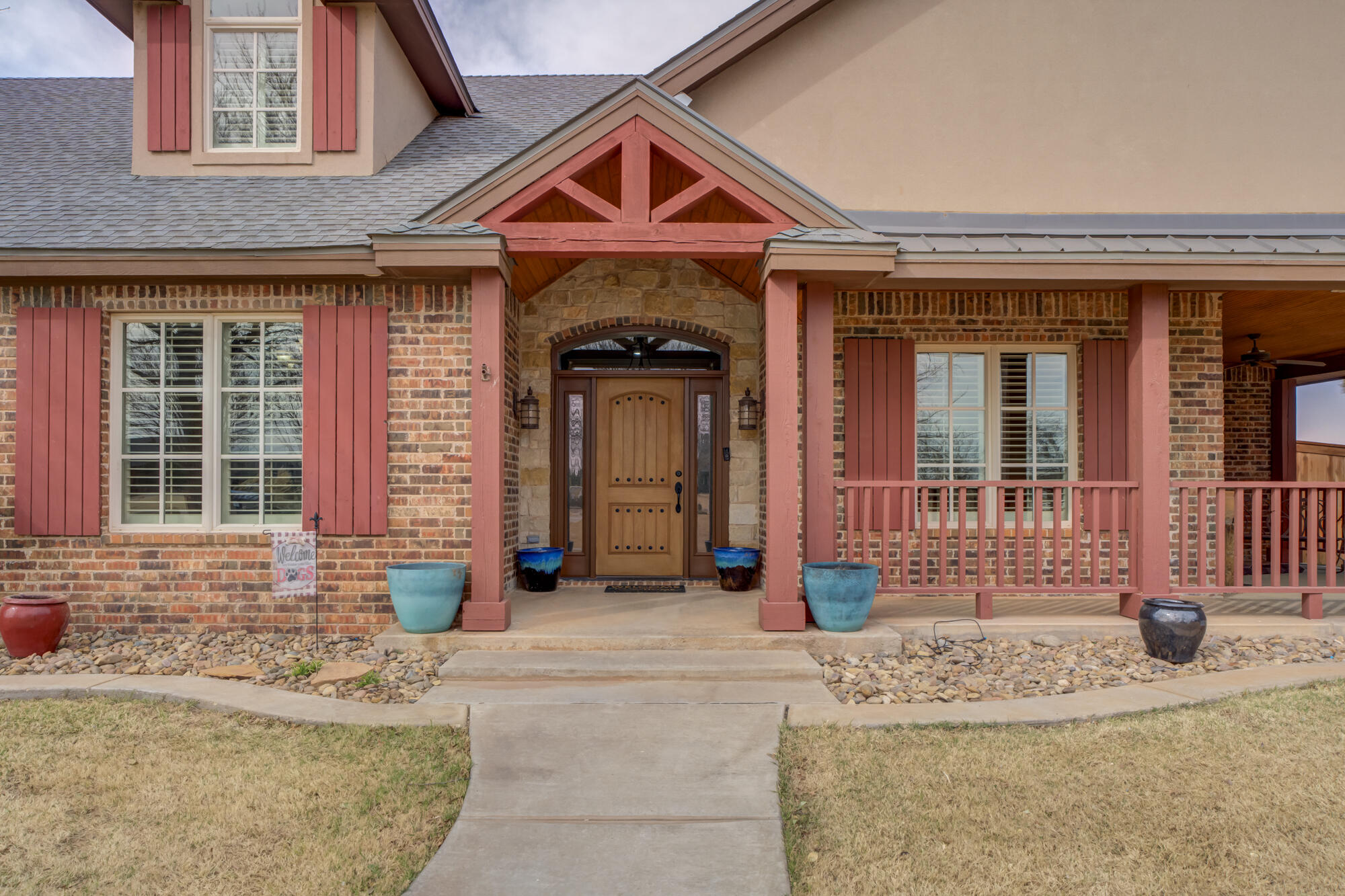 3206 County Road 7610 Lubbock, TX 79423 - Photo 7 of 93 front view of a brick house with a small yard