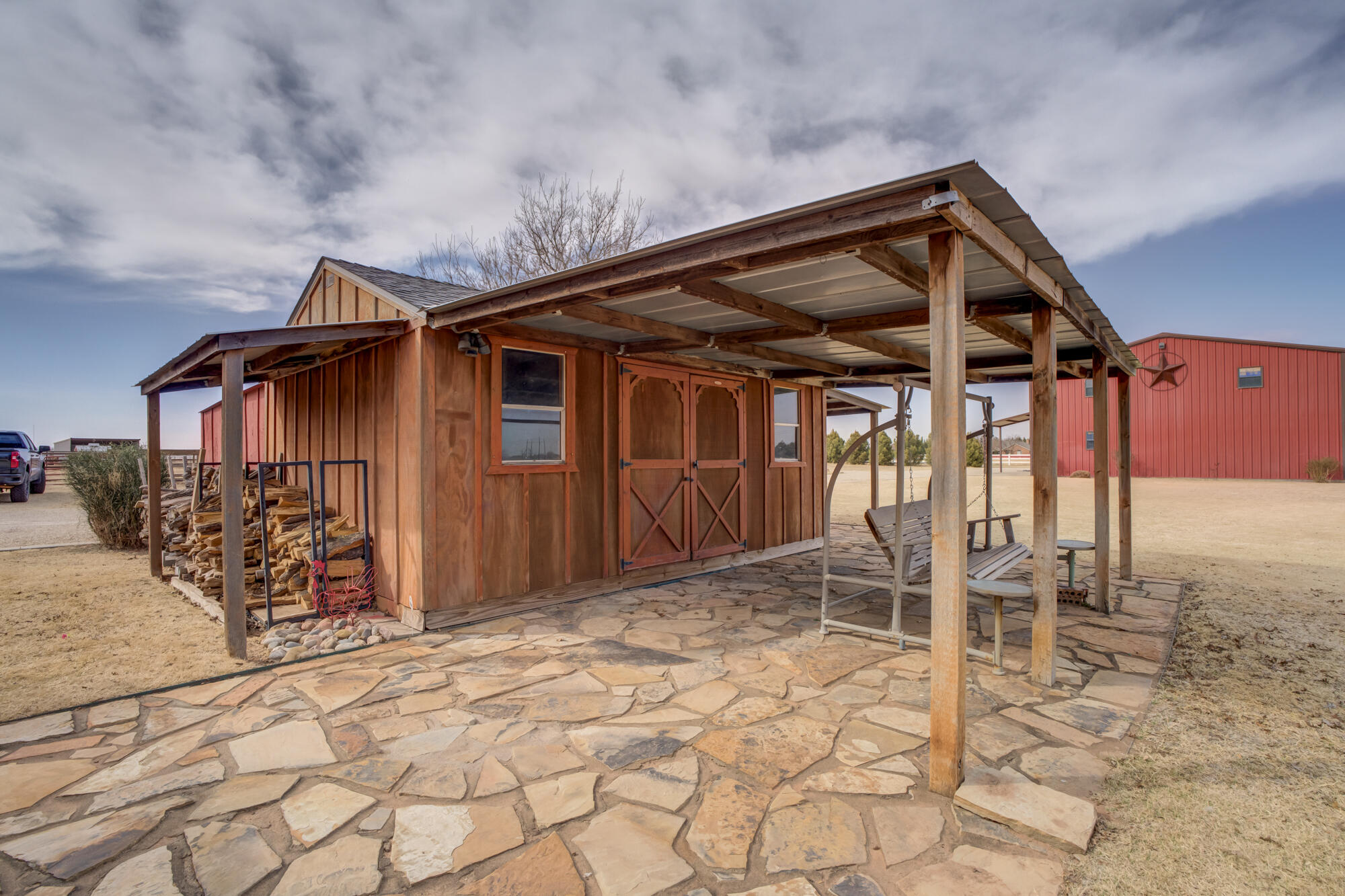 3206 County Road 7610 Lubbock, TX 79423 - Photo 75 of 93 a backyard of a house with table and chairs