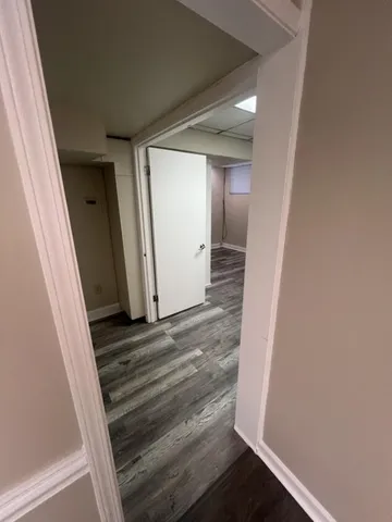 a view of a closet with wooden floor