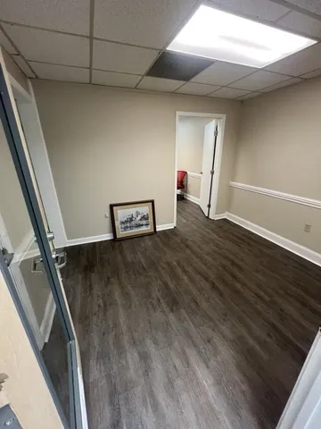 a view of a room with wooden floor and staircase