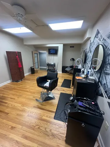 a living room with furniture gym equipment and a table