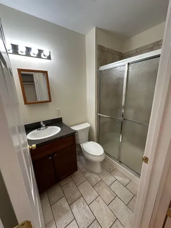 a bathroom with a toilet sink and mirror