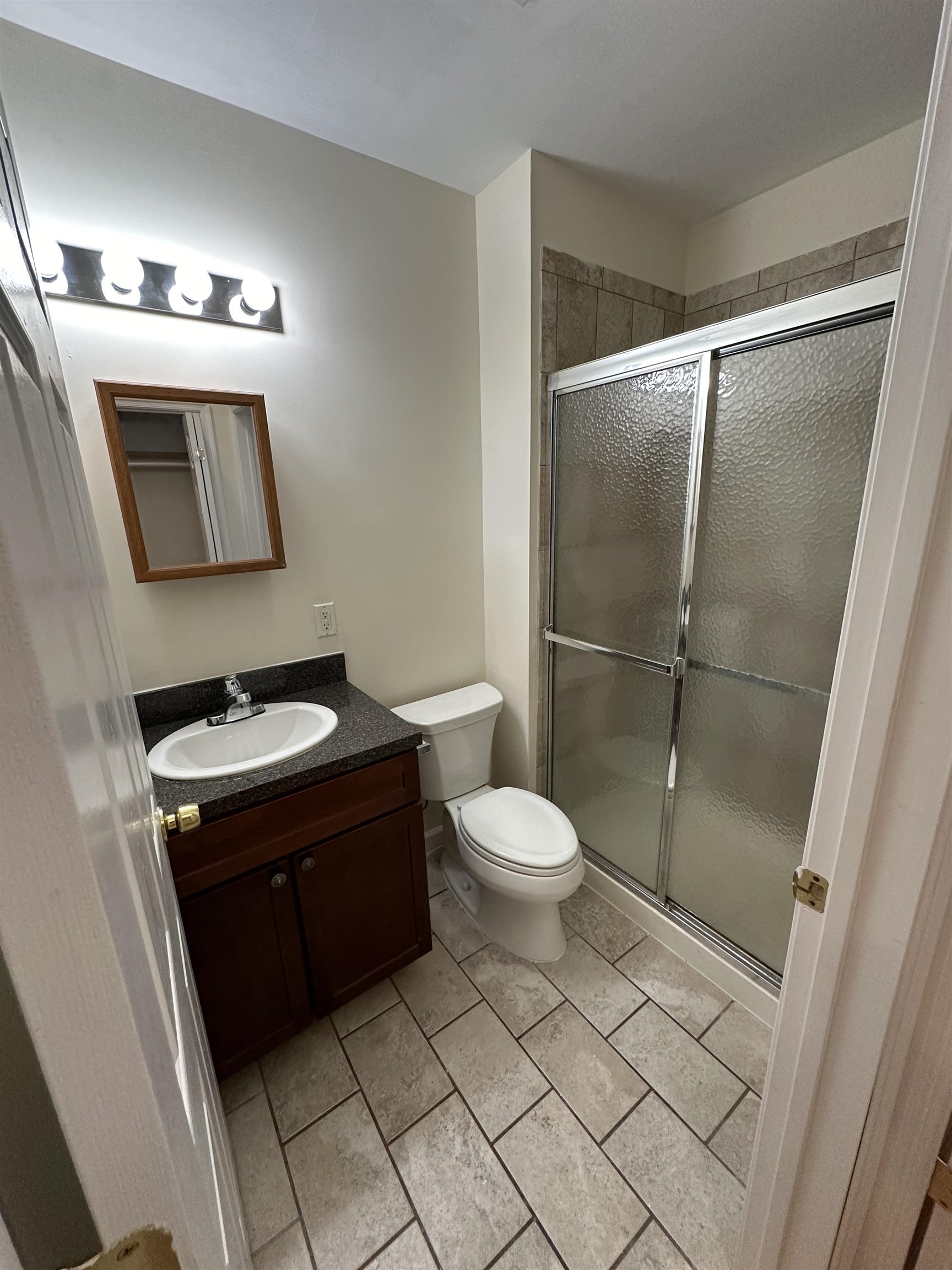 942 Willow Avenue, Unit 1L Hoboken, NJ 07030 - Photo 11 of 12 a bathroom with a toilet sink and mirror
