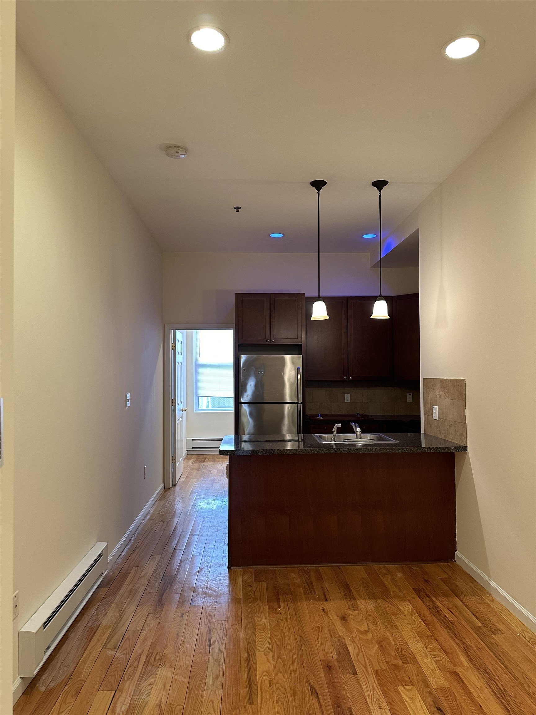 942 Willow Avenue, Unit 1L Hoboken, NJ 07030 - Photo 2 of 12 a view of a room with a window and wooden floor
