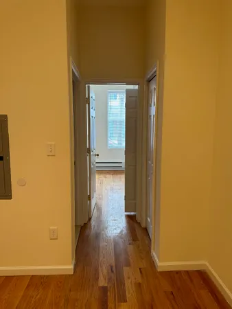 a view of a hallway with wooden floor
