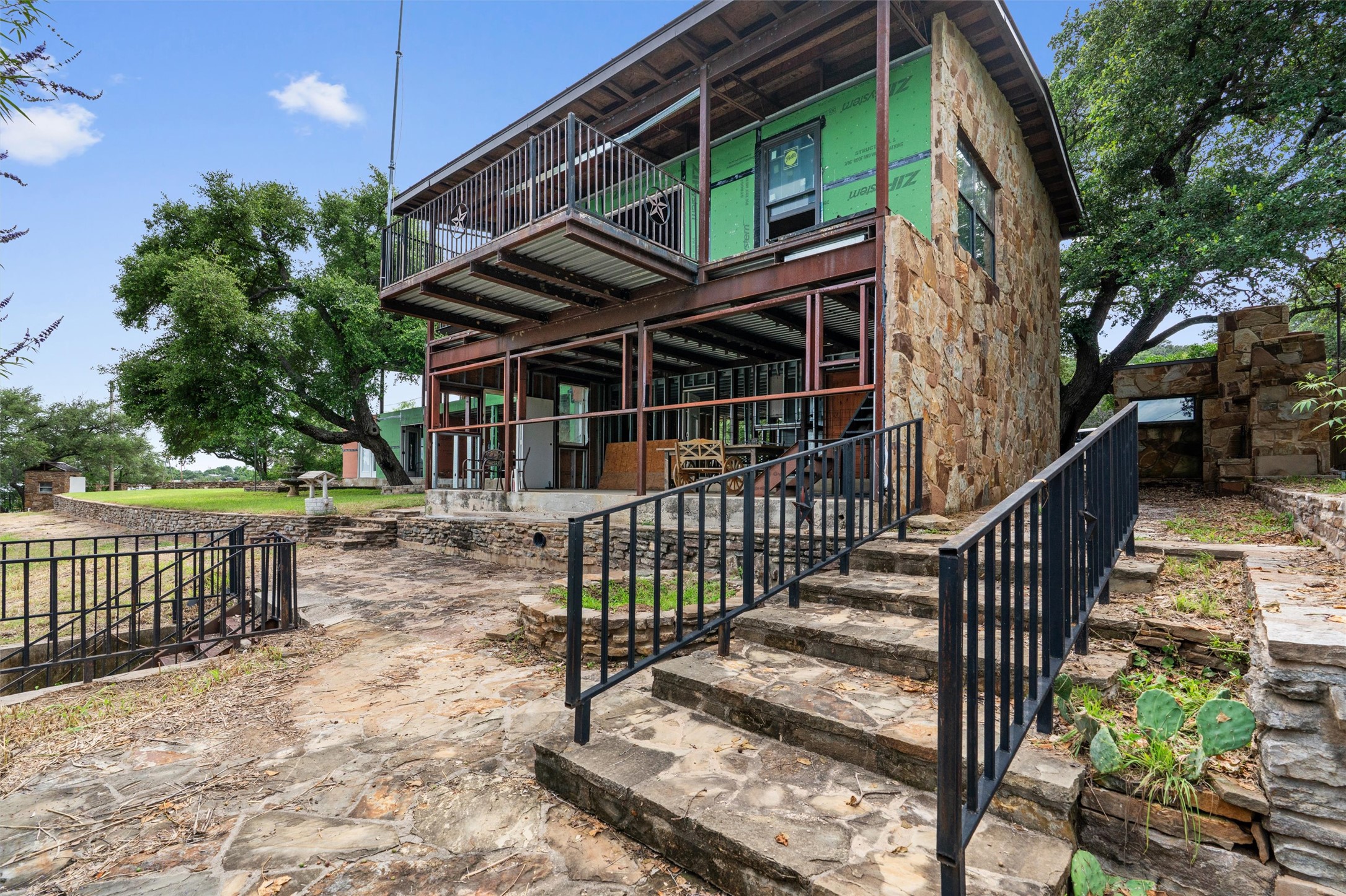 325 Eagle Rest Burnet, TX 78611 - Photo 11 of 40 A striking stone and metal home under construction features a two-story layout with expansive outdoor spaces.