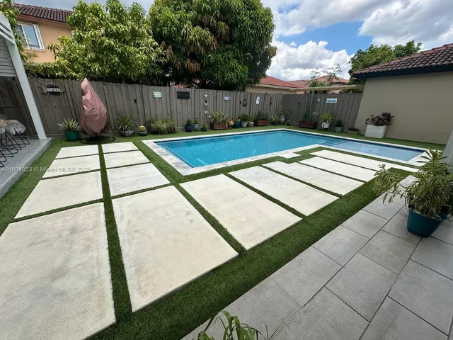 a view of a backyard with sitting area