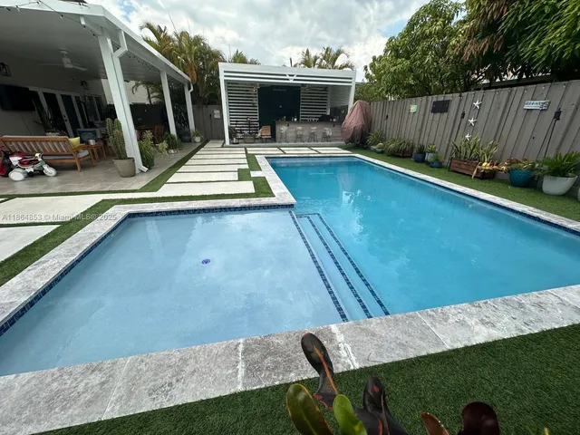 a view of swimming pool with chairs