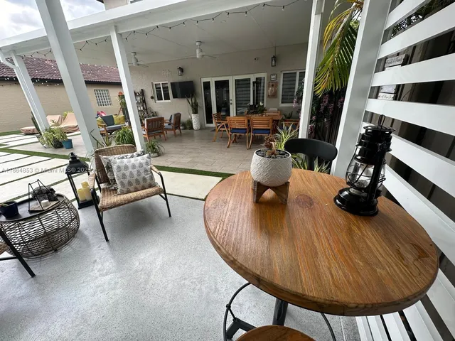 a living room with furniture and a floor to ceiling window
