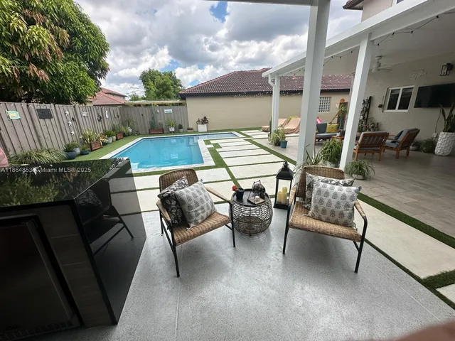a roof deck with table and chairs potted plants with wooden floor