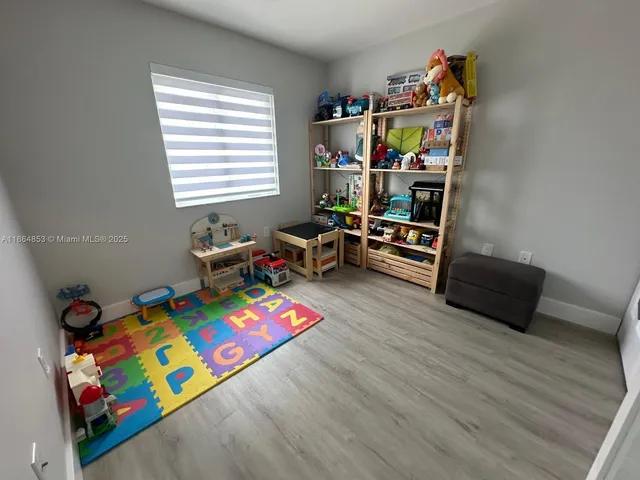 a living room with furniture and a book shelf