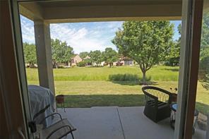 109 Ranier Lane Georgetown, TX 78633 - Photo 16 of 18 An inviting covered patio opens to a verdant yard and serene neighborhood views.