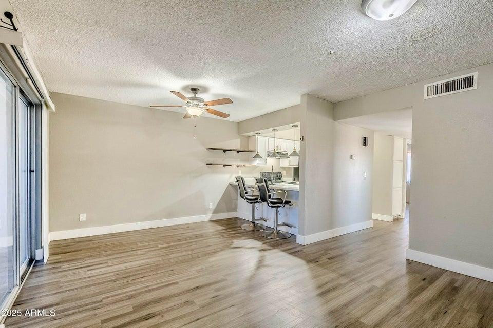1826 N Spring, Unit 201 Mesa, AZ 85203 - Photo 2 of 17 a view of a room with wooden floor and furniture