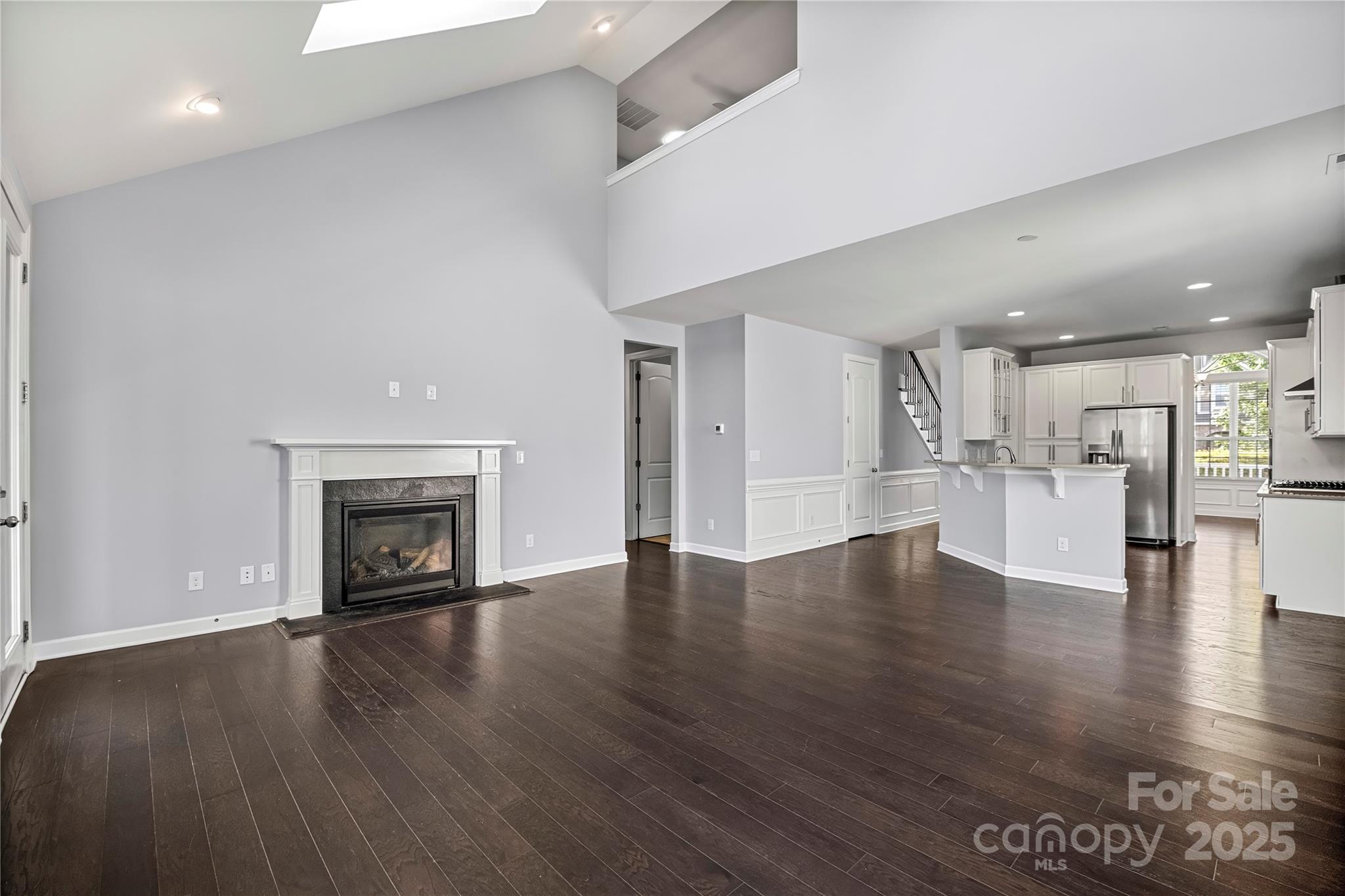 2830 Berkhamstead Circle Concord, NC 28027 - Photo 11 of 27 a view of a livingroom with wooden floor and a fireplace