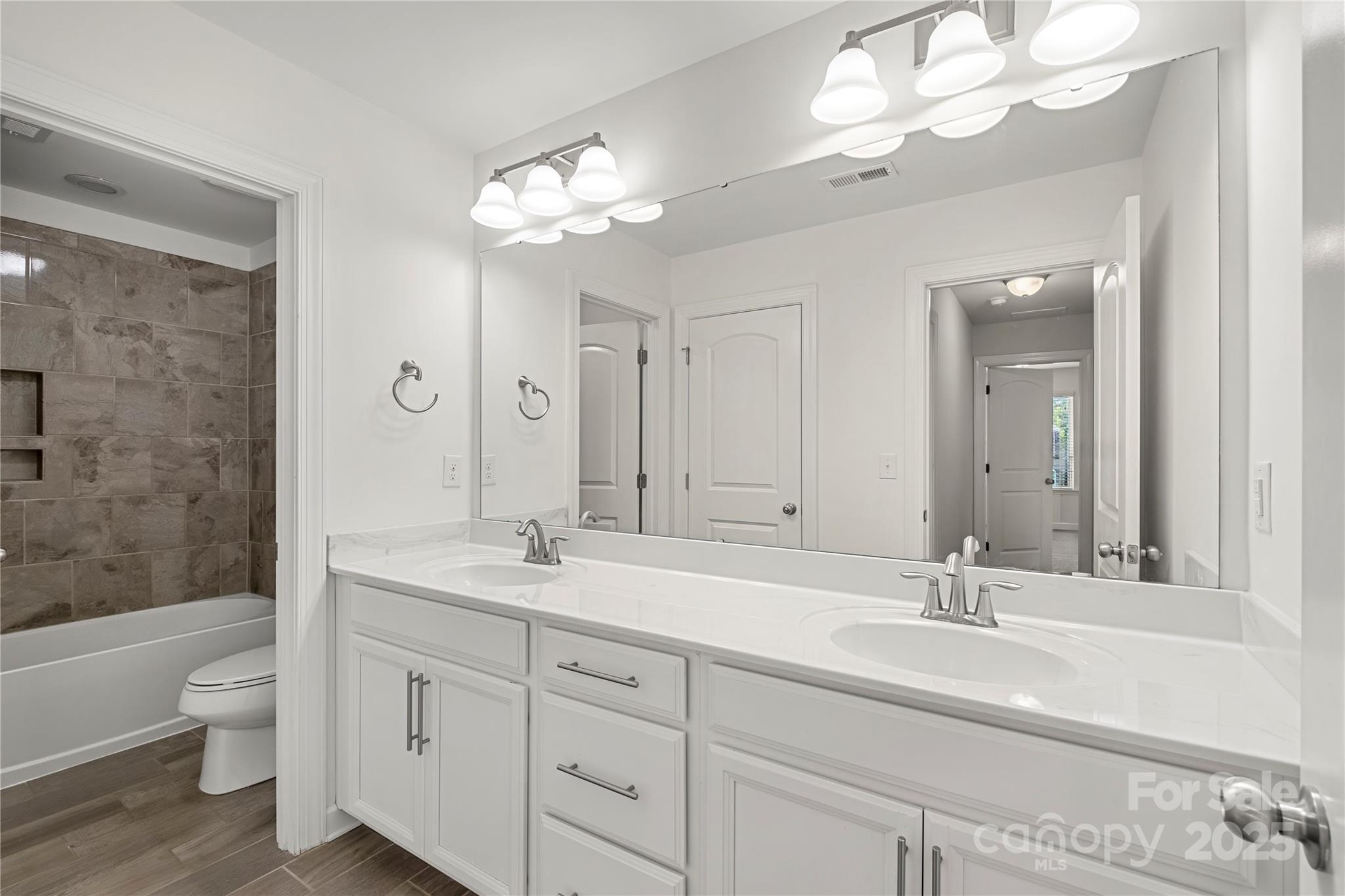 2830 Berkhamstead Circle Concord, NC 28027 - Photo 18 of 27 a bathroom with a sink a toilet and a large mirror