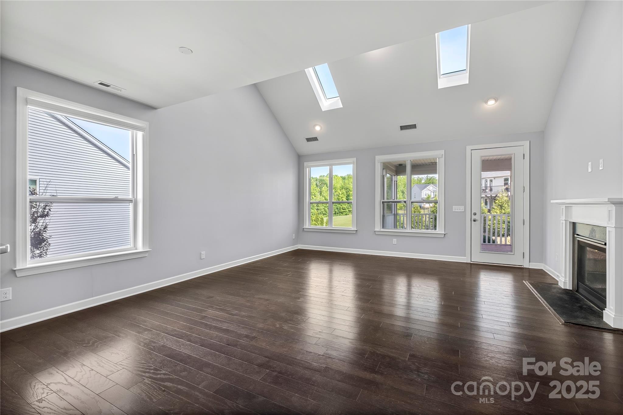 2830 Berkhamstead Circle Concord, NC 28027 - Photo 9 of 27 an empty room with wooden floor and windows