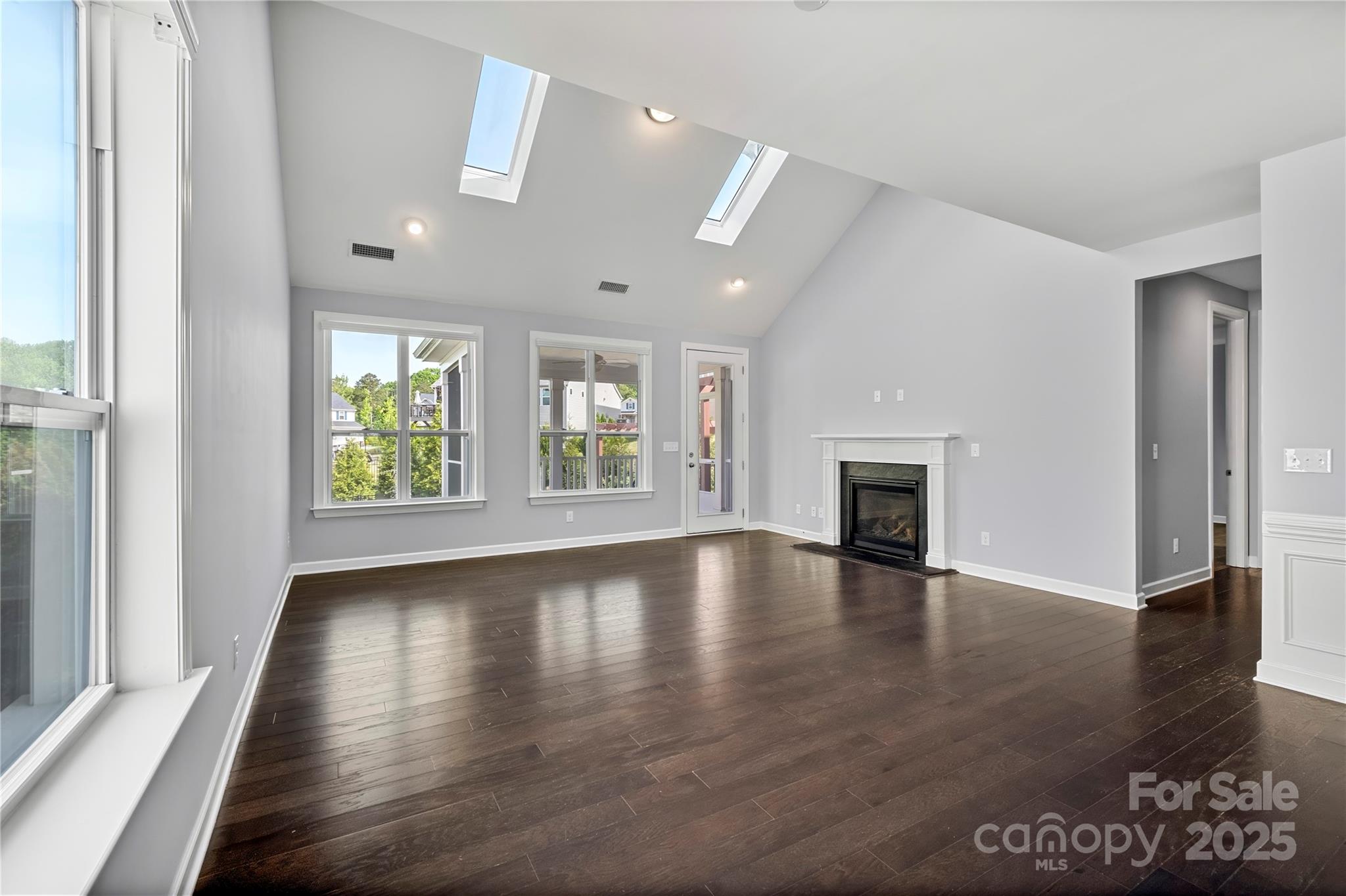 2830 Berkhamstead Circle Concord, NC 28027 - Photo 10 of 27 an empty room with wooden floor and windows