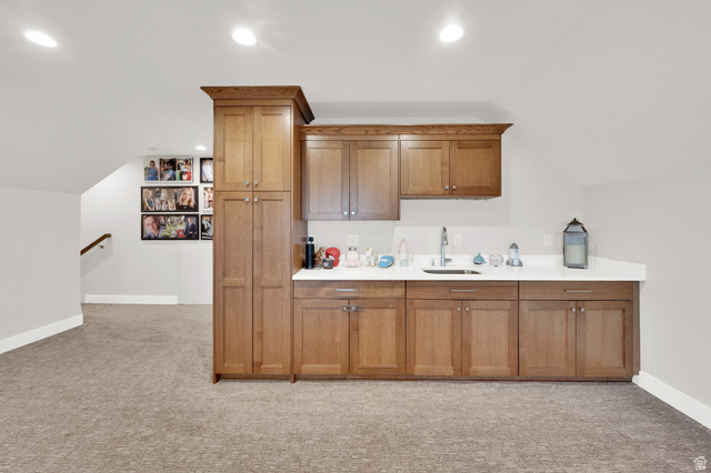 352 East Boulderville Road Oakley, UT 84055 - Photo 29 of 62 Bar area featuring light countertops, wood finish cabinetry, light colored carpet, lofted ceiling, and recessed lighting