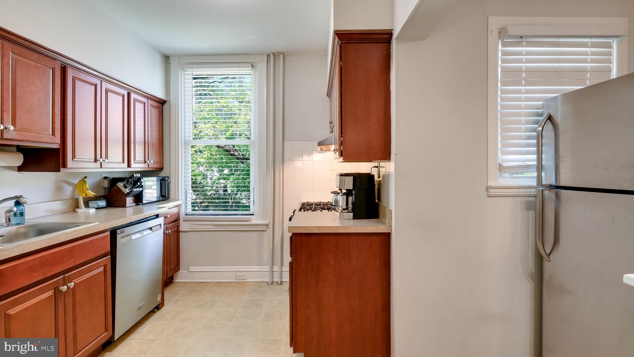 264 North Aberdeen Avenue Wayne, PA 19087 - Photo 10 of 18 a kitchen with stainless steel appliances granite countertop a refrigerator and a sink