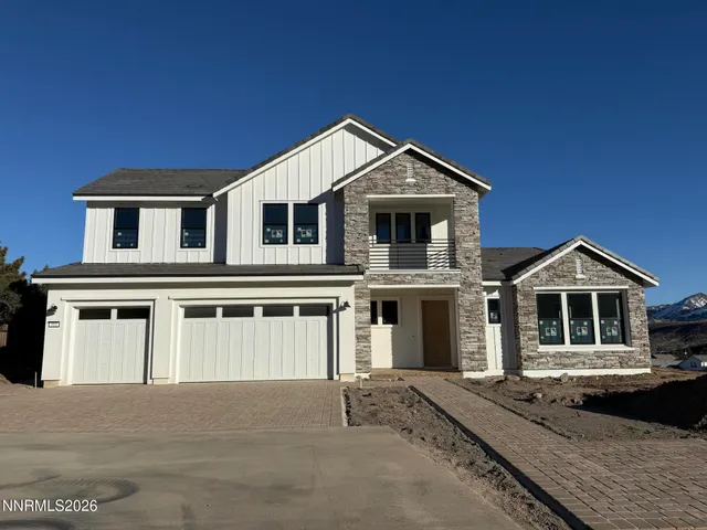 a front view of a house with garage