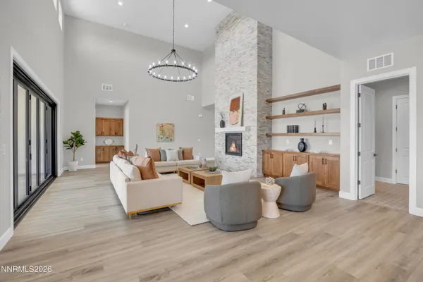 a living room with fireplace furniture and a wooden floor