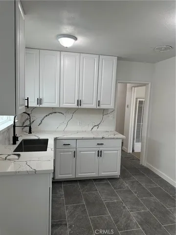 a utility room with cabinets washer and dryer
