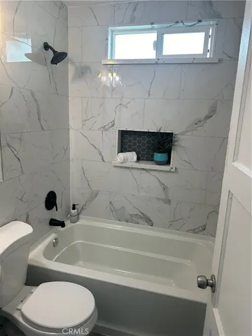 a bathroom with a toilet and a bathtub