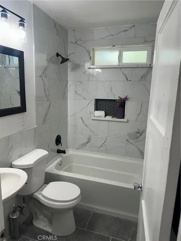 a bathroom with a toilet and a bathtub