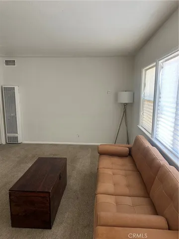 a living room with a couch and a large window