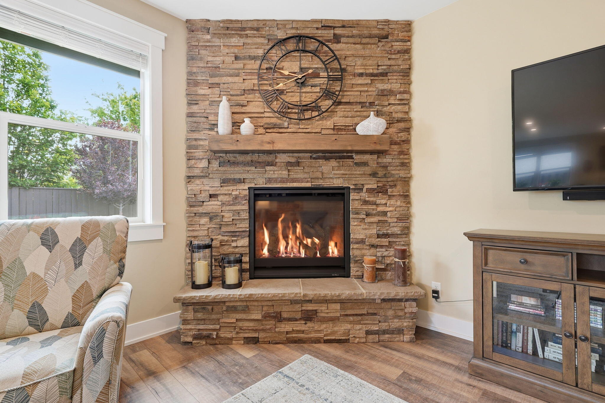 2714 Northwest 23rd Street Redmond, OR 97756 - Photo 7 of 57 a living room with a fireplace and a flat screen tv