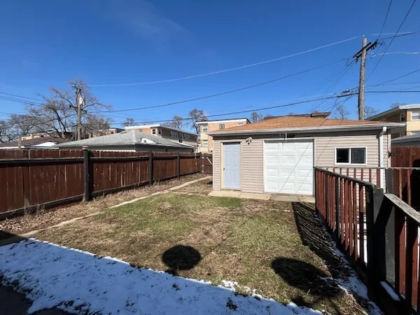 a view of a backyard with wooden fence