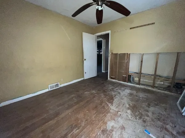 an empty room with a ceiling fan