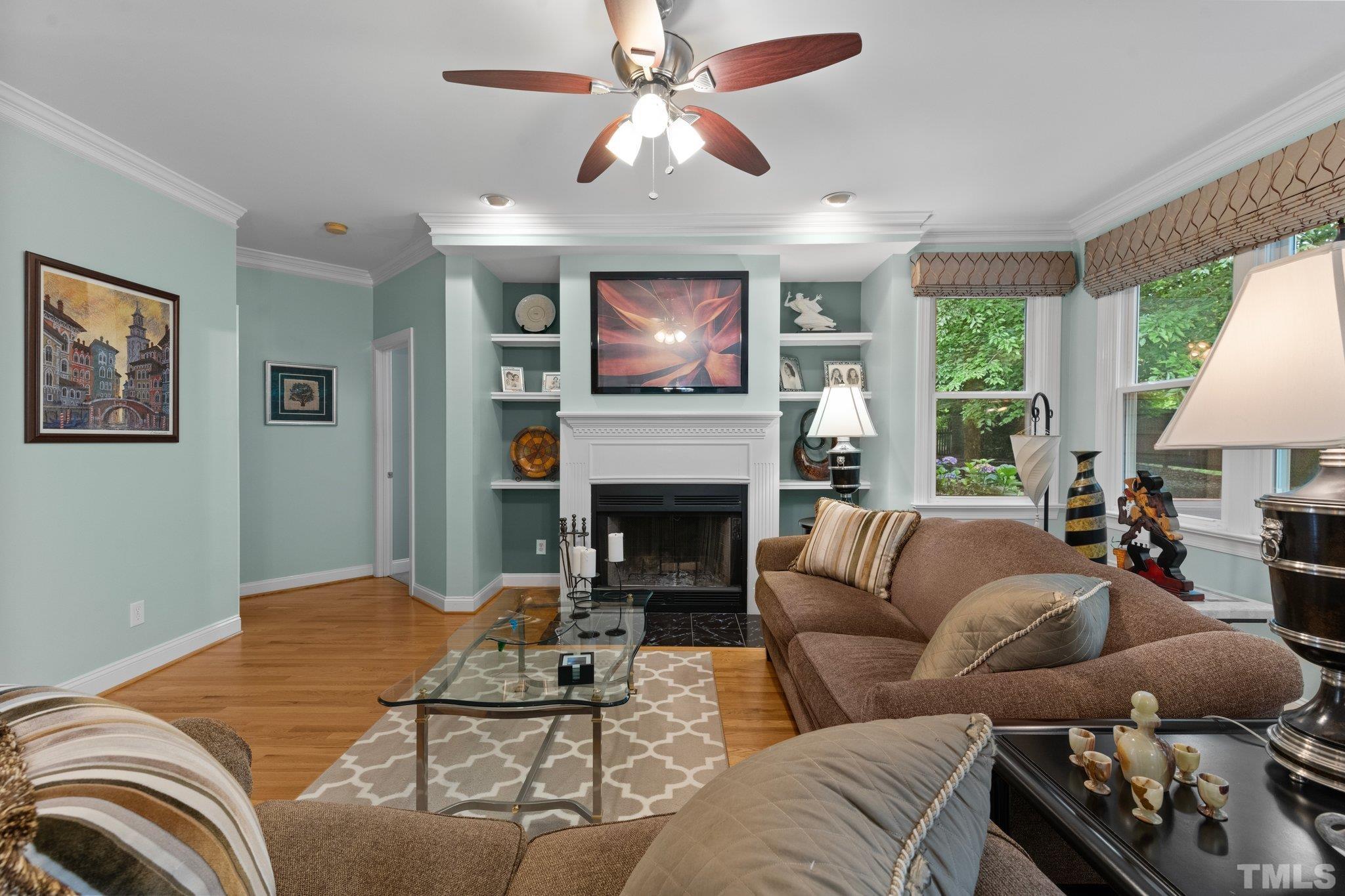 3812 Evander Way Raleigh, NC 27613 - Photo 13 of 52 a living room with furniture a fireplace and a large window