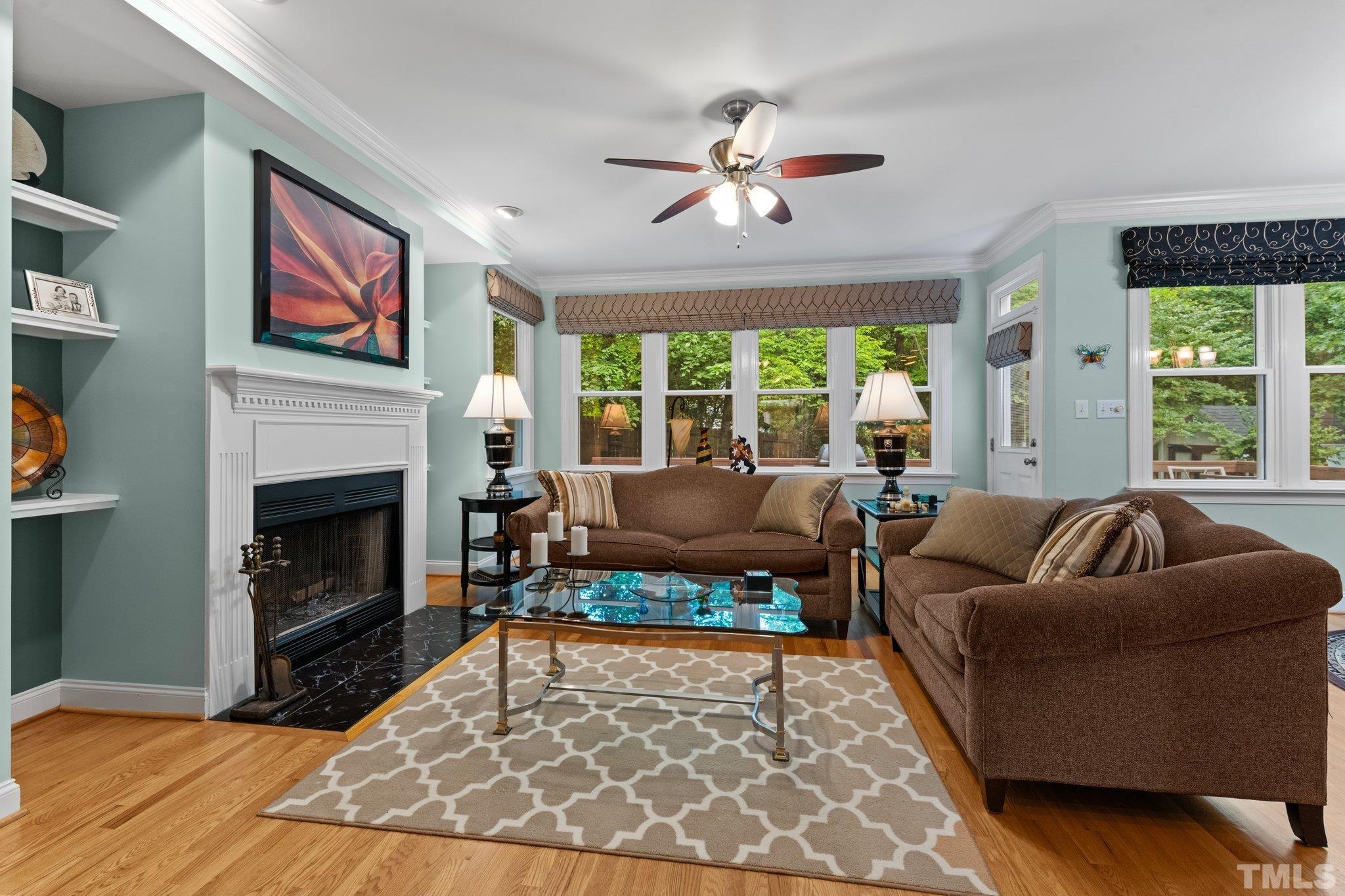 3812 Evander Way Raleigh, NC 27613 - Photo 14 of 52 a living room with furniture a rug a fireplace and a large window