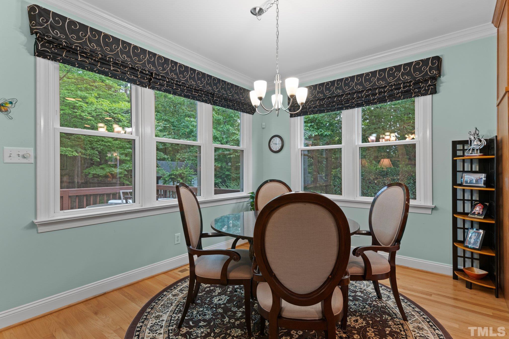3812 Evander Way Raleigh, NC 27613 - Photo 20 of 52 a dining room with furniture a chandelier and window