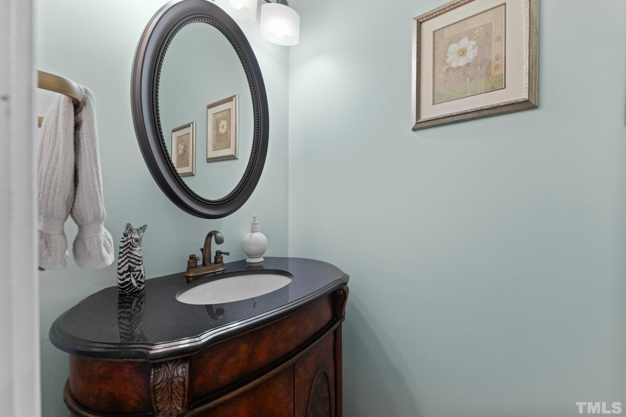3812 Evander Way Raleigh, NC 27613 - Photo 27 of 52 a bathroom with a sink and a mirror