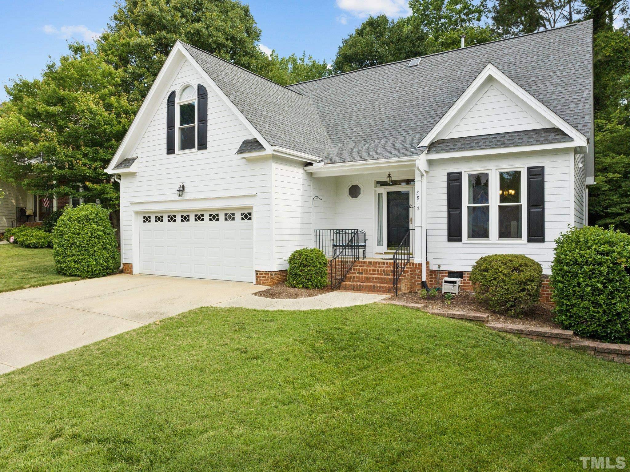 3812 Evander Way Raleigh, NC 27613 - Photo 3 of 52 a front view of a house with a yard and garage