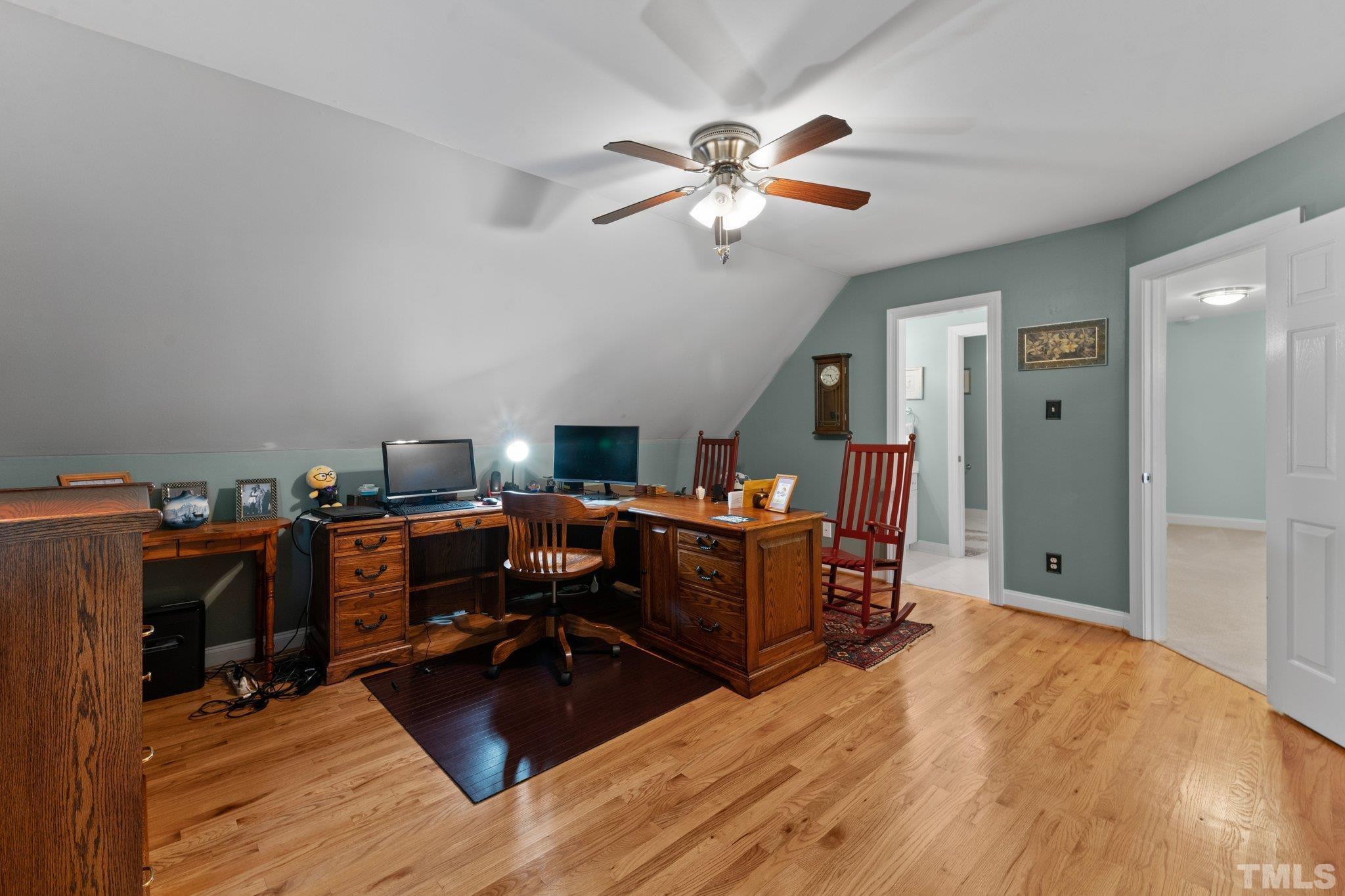 3812 Evander Way Raleigh, NC 27613 - Photo 34 of 52 a view of a workspace with furniture and a chandelier