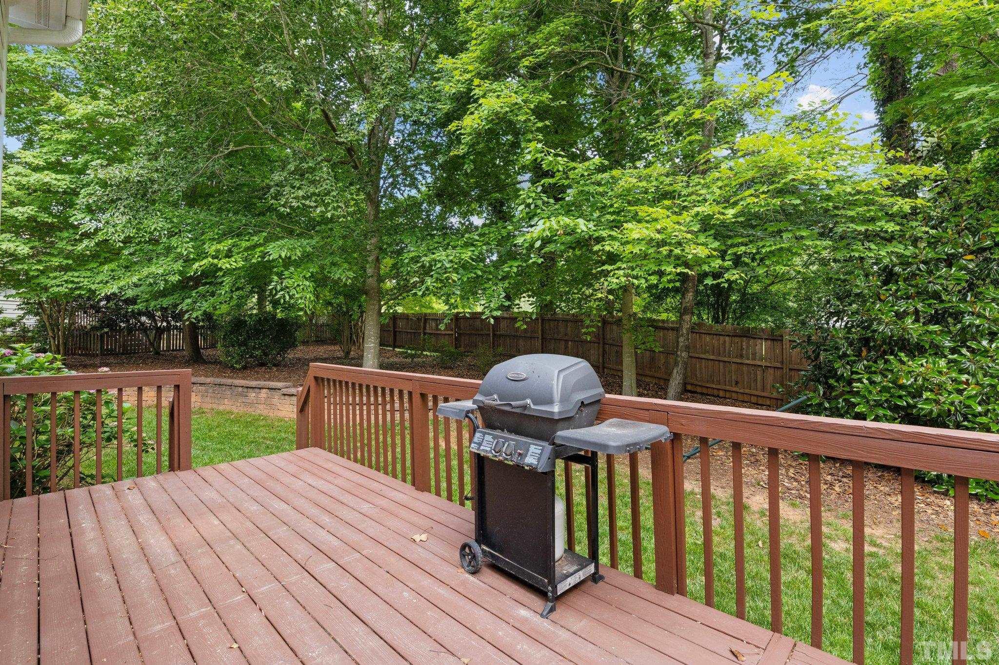 3812 Evander Way Raleigh, NC 27613 - Photo 39 of 52 a view of backyard with wooden deck and outdoor seating
