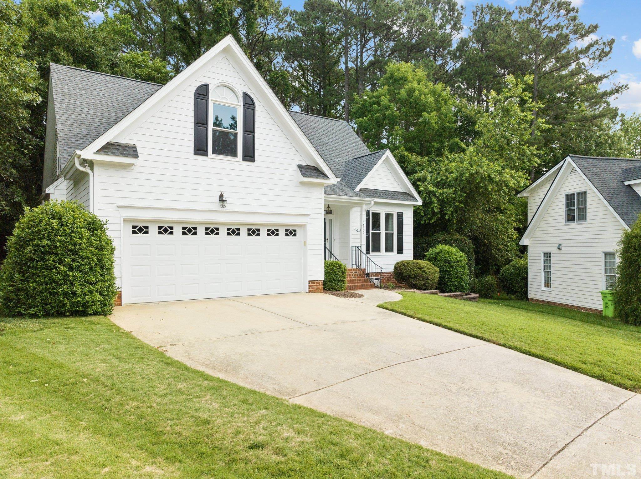 3812 Evander Way Raleigh, NC 27613 - Photo 4 of 52 a view of a white house with a yard and large trees