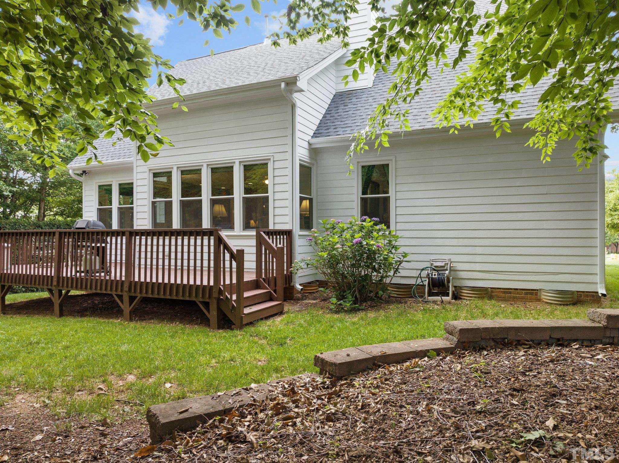 3812 Evander Way Raleigh, NC 27613 - Photo 45 of 52 a view of a house with a backyard and deck