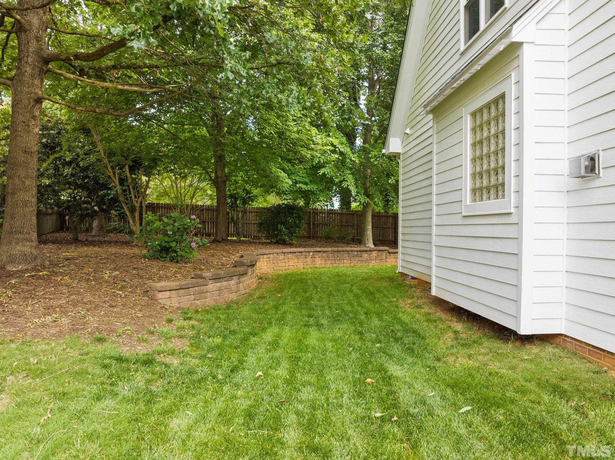 3812 Evander Way Raleigh, NC 27613 - Photo 47 of 52 a view of a backyard with a garden