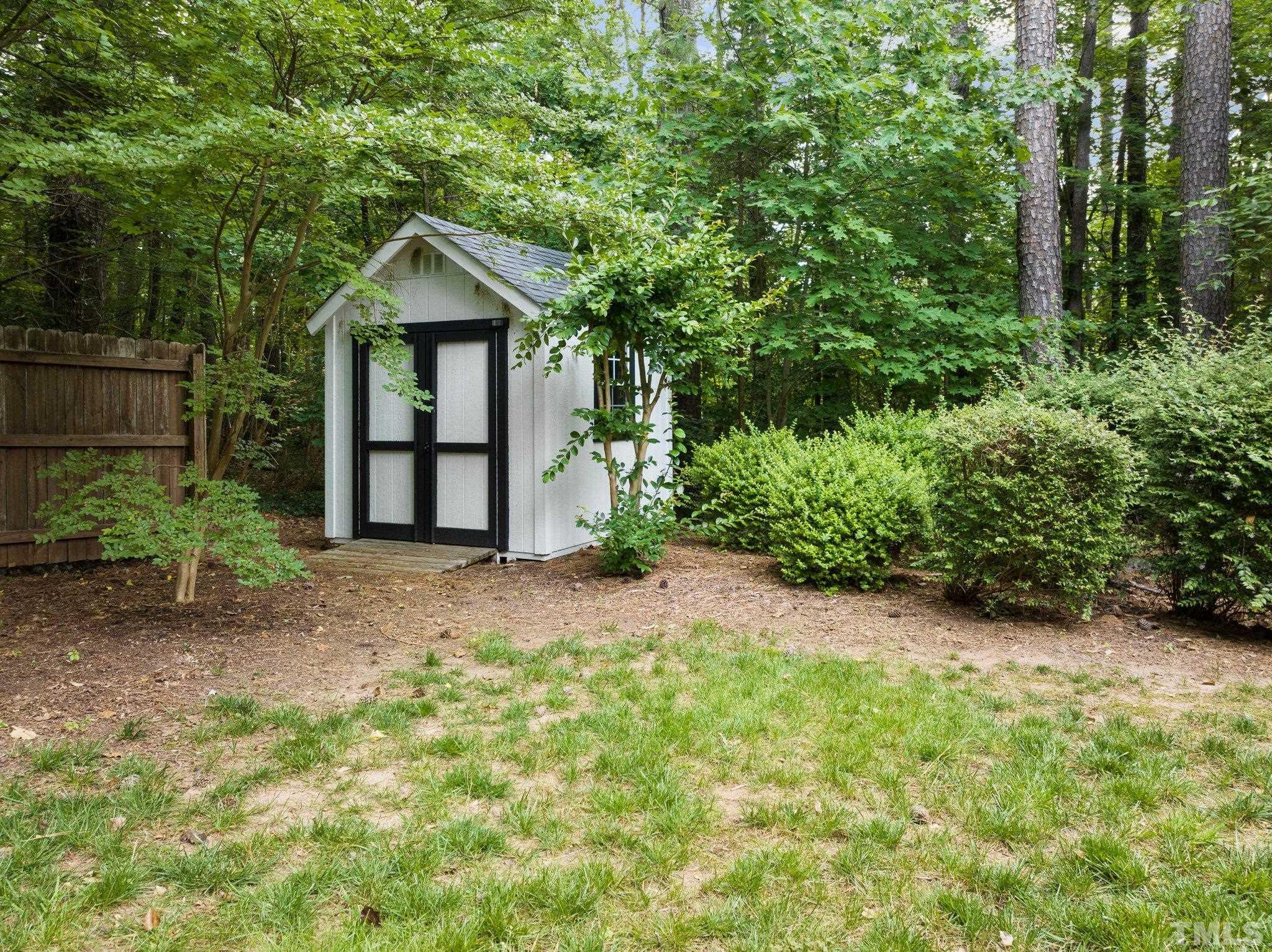 3812 Evander Way Raleigh, NC 27613 - Photo 50 of 52 a view of a house with large trees and plants