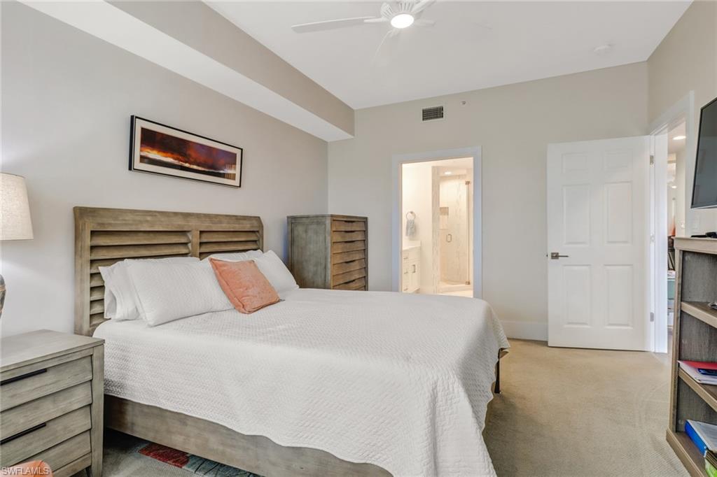 401 Bayfront Place, Unit 3306 Naples, FL 34102 - Photo 13 of 26 a bedroom with a bed and a refrigerator