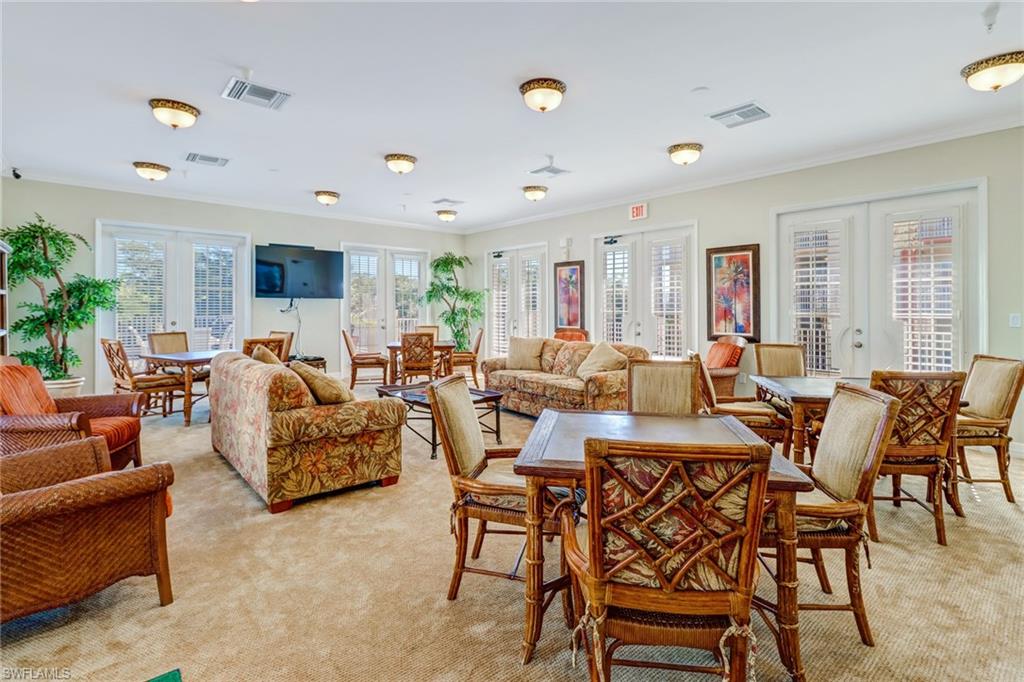 401 Bayfront Place, Unit 3306 Naples, FL 34102 - Photo 24 of 26 a living room with furniture dining table and a potted plant