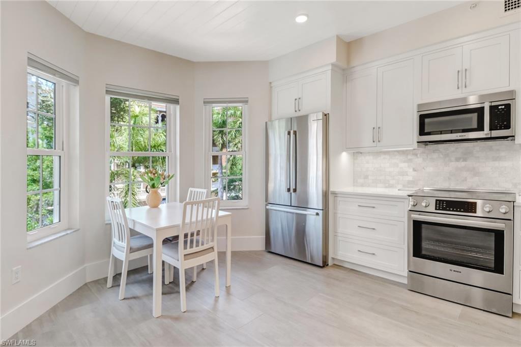 401 Bayfront Place, Unit 3306 Naples, FL 34102 - Photo 7 of 26 a kitchen with stainless steel appliances a stove microwave and refrigerator