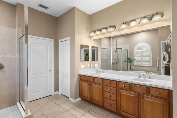 a spacious bathroom with a double vanity sink mirror and