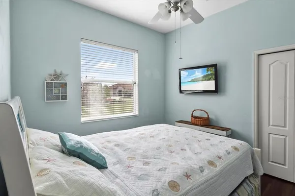 a bedroom with a bed and a chandelier